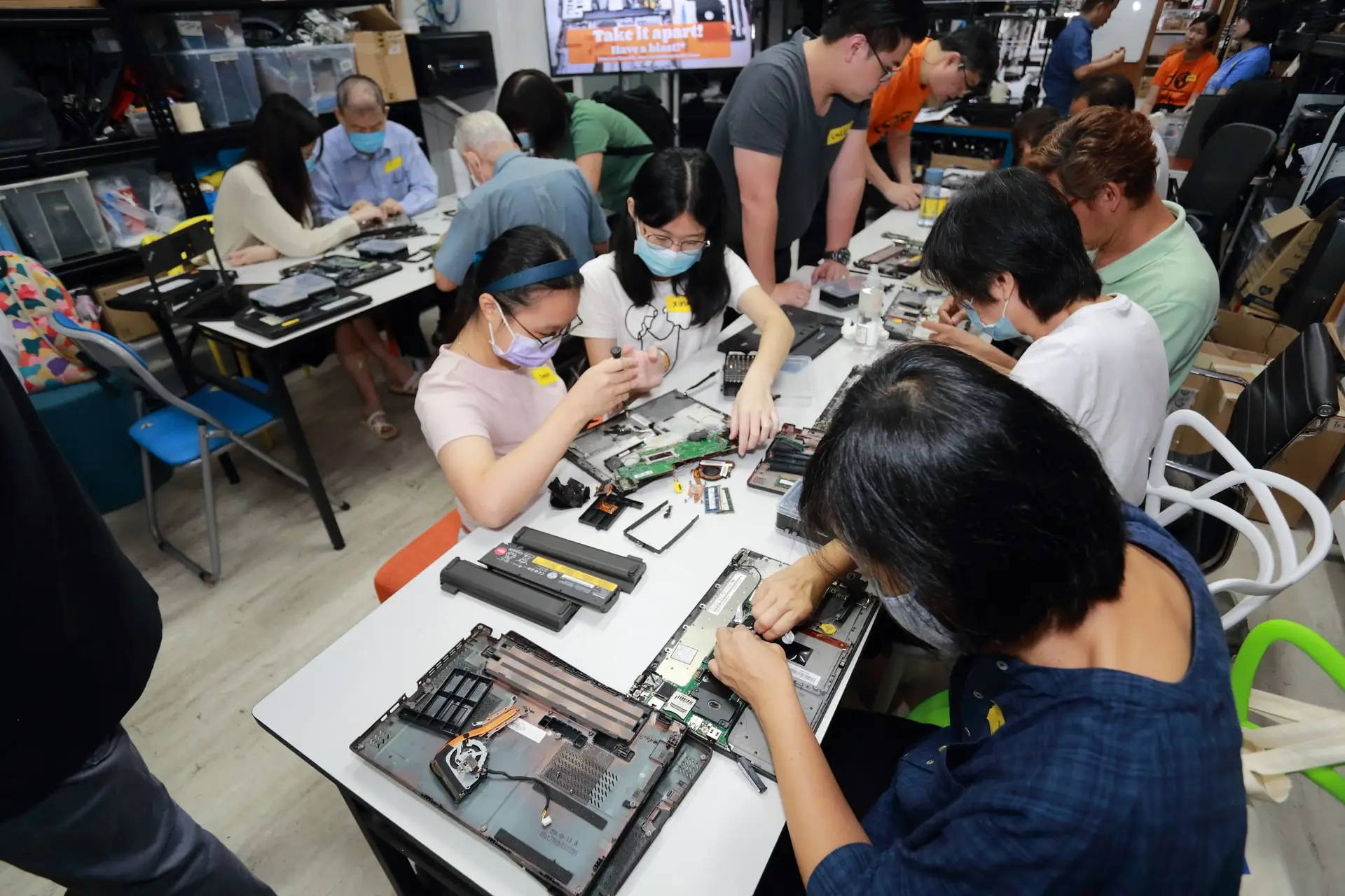 Volunteers at Engineering Good, a tech and engineering charity in Singapore, refurbishing laptops for vulnerable and low-income communities.